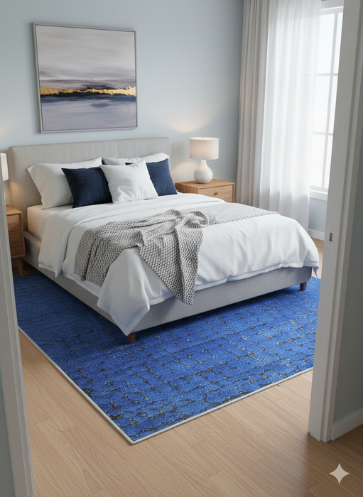 5' x 7' Rectangle Blue & Charcoal Abstract Modern Area Rug placed in a cozy bedroom setting.