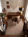 5' x 7' Rectangular Beige & Brown Floral Traditional Washable Area Rug placed in a warm home office beneath a wooden desk.