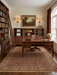 5' x 7' Rectangular Brown & Beige Floral Traditional Washable Area Rug styled in a traditional home office beneath a wooden executive desk.