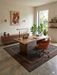 5' x 7' Rectangular Charcoal & Red Minimalist Tribal Border Modern Area Rug styled in a home office with a wooden desk and modern seating.