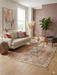 5' x 7' Rectangular Coral & Beige Tribal Medallion Distressed Traditional Area Rug styled in a cozy living room with sofa, armchair, and glass coffee table.