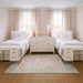 5' x 7' Rectangular Pink Multicolor Floral Traditional Washable Area Rug placed in a charming girls’ bedroom between two twin beds with pink monogram pillows and white furniture.