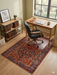 5' x 7' Rectangular Red & Blue Tribal Geometric Medallion Traditional Area Rug styled in a home office with a desk and rolling chair.