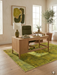 5' x 7' rectangular yellow & green distressed abstract modern area rug placed in a home office with a wooden desk and minimalist decor.