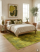 5' x 7' rectangular yellow & green distressed abstract modern area rug styled in a light-filled bedroom with soft bedding and warm wood tones.