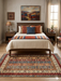 5' x 8' Rectangular Beige Multicolor Striped Floral Traditional Area Rug placed in a cozy bedroom with warm wood furniture and Southwestern-inspired accents.