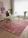 5' x 8' Rectangular Blush Pink Distressed Modern Area Rug styled in a modern home office.