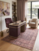 5' x 8' Rectangular Brown Beige Distressed Modern Abstract Area Rug featured in a stylish home office with curved desk and upholstered chair.