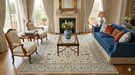 5' x 8' Rectangular Ivory Blue Floral Traditional Oriental Area Rug styled in a traditional living room.