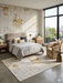 5' x 8' Rectangular Ivory & Gold Distressed Abstract Modern Washable Area Rug styled in a bedroom with neutral tones and gold accents.