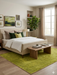 5' x 8' Rectangular Lime Green Solid Contemporary Area Rug placed in a serene bedroom with natural wood furniture and botanical décor.