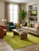 5' x 8' Rectangular Lime Green Solid Contemporary Area Rug styled in a modern living room with neutral furniture and green accents.