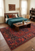 5' x 8' Rectangular Red & Navy Tribal Geometric Traditional Washable Area Rug styled in a bedroom with wood furniture and layered bedding.