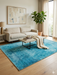 5' x 8' Rectangular Teal & Aqua Distressed Abstract Modern Area Rug styled in a living room with neutral seating and soft textures.