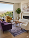 5' x 8' rectangular gray & lavender distressed abstract modern area rug styled in a bright living room with a fireplace and contemporary seating.