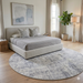 6' Round Beige & Gray Distressed Abstract Modern Area Rug styled in a bedroom with soft neutral bedding and natural light.