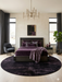 6' Round Black Plum Solid Contemporary Area Rug placed in an elegant bedroom with rich purple bedding and dramatic contemporary décor.