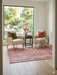 6' x 6' Square Blush Pink & Ivory Distressed Floral Traditional Area Rug styled in a cozy seating nook with accent chairs and a side table.