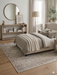 6' x 6' Square Light Gray & Ivory Distressed Medallion Traditional Area Rug styled in a bedroom with layered bedding and minimalist decor.