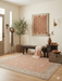 6' x 6' Square Peach & Ivory Floral Medallion Traditional Washable Area Rug placed in a welcoming entryway with a wooden bench.