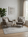 6' x 6' square light gray & ivory distressed abstract modern area rug styled in a cozy seating area with two upholstered chairs and a small round table.