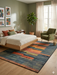 6' x 9' Rectangular Blue & Orange Geometric Modern Area Rug styled in a bedroom with clean lines and modern furnishings.