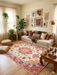 6' x 9' Rectangular Cream & Pink Floral Oriental Traditional Area Rug styled in a living room with layered textiles and relaxed boho decor.