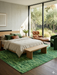 6' x 9' Rectangular Green Distressed Abstract Modern Area Rug styled in a bedroom with neutral bedding and mid-century accents.