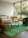 6' x 9' Rectangular Green Distressed Abstract Modern Area Rug styled in a living room with modern seating and natural light.