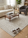 6' x 9' Rectangular Ivory & Beige Geometric Textured Modern Washable Area Rug styled in a living room with a neutral sofa, accent chair, and minimal decor.