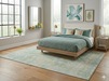 6' x 9' Rectangular Mint Green Distressed Medallion Traditional Washable Area Rug placed under a bed in a serene bedroom with mint bedding and gold accent lamps.