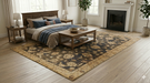 6' x 9' Rectangular Navy & Beige Floral Traditional Washable Area Rug styled in a bedroom with warm wood furniture and layered bedding.