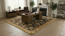 6' x 9' Rectangular Navy & Beige Floral Traditional Washable Area Rug styled in a home office with a wooden desk, shelving, and natural light.