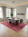 6' x 9' Rectangular Red & Pink Distressed Abstract Modern Area Rug styled in a bedroom with neutral bedding and modern decor.