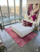 6' x 9' Rectangular Rose Pink Distressed Abstract Modern Area Rug styled in a bedroom with a platform bed and modern decor.