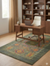 6' x 9' rectangular olive green & multicolor floral medallion traditional area rug placed in a home office with a wooden desk, modern chair, and built-in shelving.