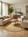 7' Round Beige & Natural Solid Textured Jute-Style Area Rug styled in a living room with neutral seating and warm wood accents.