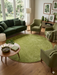 7 ft Round Green Solid Shag Modern Contemporary Area Rug styled in a cozy living room.