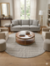 7 ft Round Ivory & Gray Textured Minimalist Modern Washable Area Rug styled in a contemporary living room.