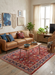 7' x 10' Rectangle Red & Navy Floral Traditional Washable Area Rug styled in a welcoming living room with a leather sofa, wood coffee table, and boho-inspired décor.