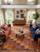 7' x 10' Rectangular Brown & Rust Checkered Geometric Modern Washable Area Rug styled in a living room with neutral decor and layered textiles.