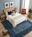 7' x 10' Rectangular Gray & Blue Solid Textured Modern Area Rug placed beneath a bed in a modern bedroom.