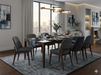 7' x 10' Rectangular Gray Charcoal Distressed Abstract Modern Washable Area Rug shown in a sophisticated dining room with dark wood furniture, upholstered chairs, and urban views.