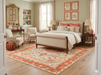 7' x 10' Rectangular Ivory & Coral Floral Medallion Traditional Area Rug placed beneath a bed in a classic bedroom setting.