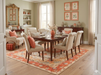 7' x 10' Rectangular Ivory & Coral Floral Medallion Traditional Area Rug styled under a formal dining table in a sophisticated dining room.