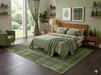 7' x 10' Rectangular Olive Green Textured Plaid Modern Area Rug placed in a serene bedroom with matching green bedding and mid-century wood furniture.