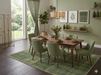 7' x 10' Rectangular Olive Green Textured Plaid Modern Area Rug showcased in a contemporary dining room with green upholstered chairs and warm walnut finishes.