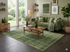 7' x 10' Rectangular Olive Green Textured Plaid Modern Area Rug styled in a cozy living room with sage green furnishings and natural wood accents.