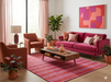 7' x 10' Rectangular Red Pink Striped Contemporary Area Rug styled in a modern living room with blush and magenta accents.