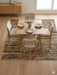 7' x 7' Square Beige & Brown Abstract Modern Area Rug styled in a dining area with light wood furniture and simple table settings.